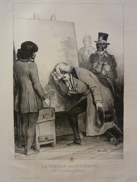 Black and white illustration depicting a scene in an art studio. Features a painter with long hair and a man with facial hair, both examining a painting on an easel. Another figure, wearing a top hat and monocle, observes them, next to a statue in armor. The setting includes elements typically associated with art critics and painters during the July Monarchy era.