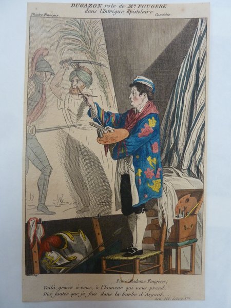 This image depicts an artist in a smock, holding a palette and a brush, painting a scene on an easel that includes figures in armor. A mahlstick, various artists' brushes, and additional palettes can be seen around the studio setting. In the background, part of a draped curtain is visible, emphasizing the indoor studio environment.