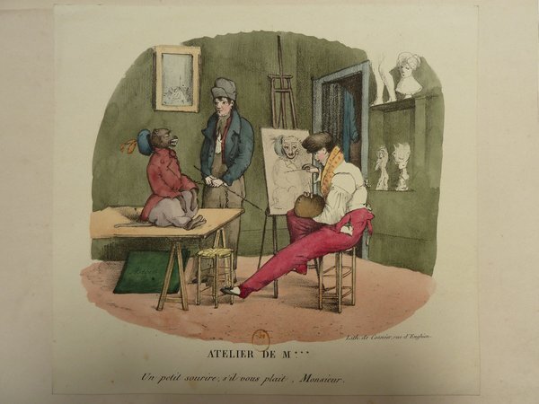Artistic studio setting featuring a monkey portrayed as a painter's model sitting on a table, another monkey engaged in painting at an easel, and various art tools like palettes and brushes. The studio is decorated with paintings, a statue, and restoration items.