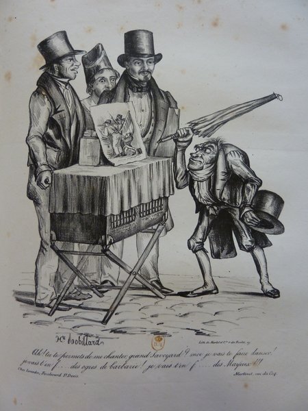 Historical black and white illustration depicting four caricatured men on a street during the July Monarchy era. Three men wear top hats and are gathered around a fourth, caricature figure with his head serving also as his torso, holding a umbrella and displaying a book or sketch. The setting appears to be an outdoor book selling event. All men exhibit facial hair.