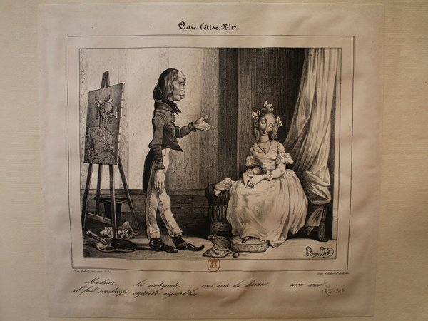 A black and white print showing a painter with a palette and brush facing a woman sitting with a book, both in attire from the July Monarchy era. The woman is wearing a dress with a hat, seated near drapery, in a studio setting with an easel and painting. There are also artists' brushes and a top hat on the floor nearby.