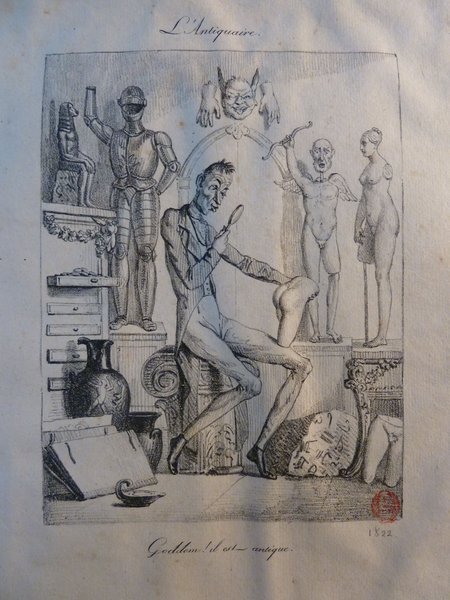 An etching showing a scene inside an antique collector's workspace, featuring Greco-Roman and Egyptian antiques, a statue resembling a satyr, and a suit of armor. A figure, presumably an art critic, examines an object with a loupe. The room is cluttered with various statuettes, a folio, and artifacts.