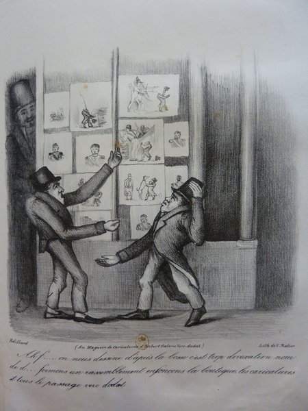 Image depicts three caricatured men in top hats involved in a lively exchange outside a shop or gallery, which displays multiple framed caricatures. One character, with a hat, appears from behind a dividing panel, while another points at a caricature. The print is from the July Monarchy era and is associated with publisher Mayeux.